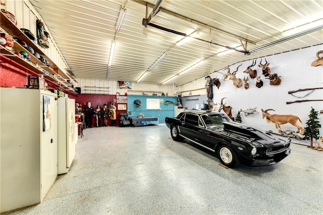 garage with white refrigerator with ice dispenser