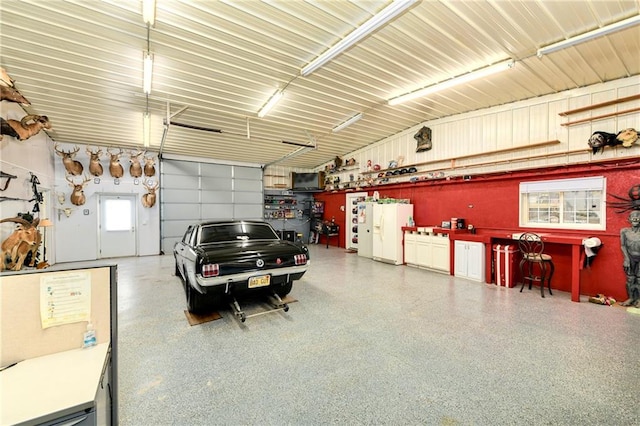 garage with white refrigerator with ice dispenser