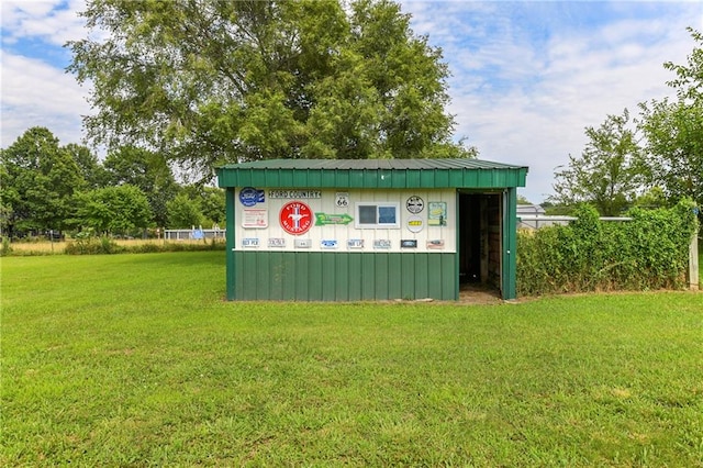 view of outdoor structure featuring a lawn