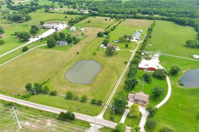 drone / aerial view featuring a water view and a rural view