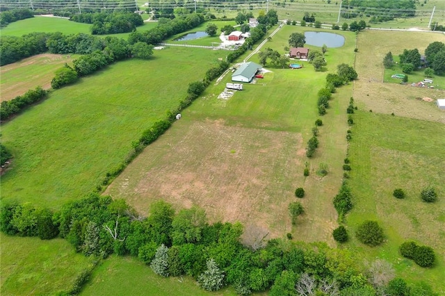 birds eye view of property featuring a rural view and a water view