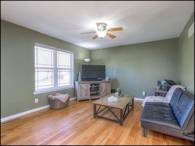 living room featuring ceiling fan and light wood-type flooring