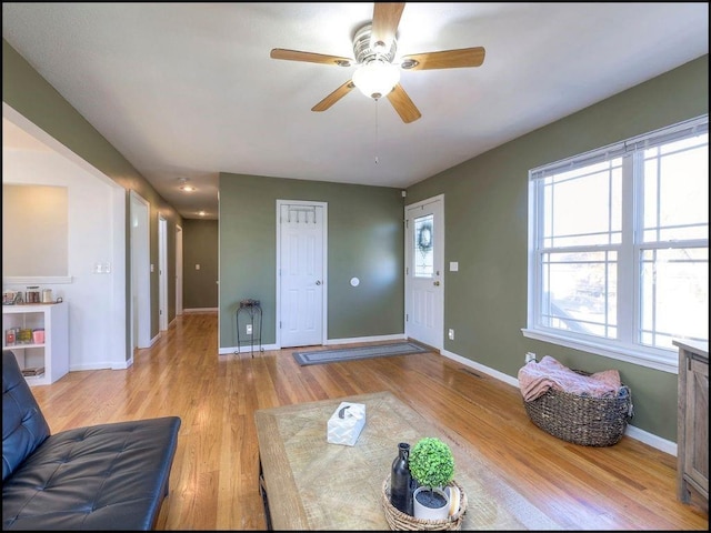 living room featuring ceiling fan and light wood-type flooring