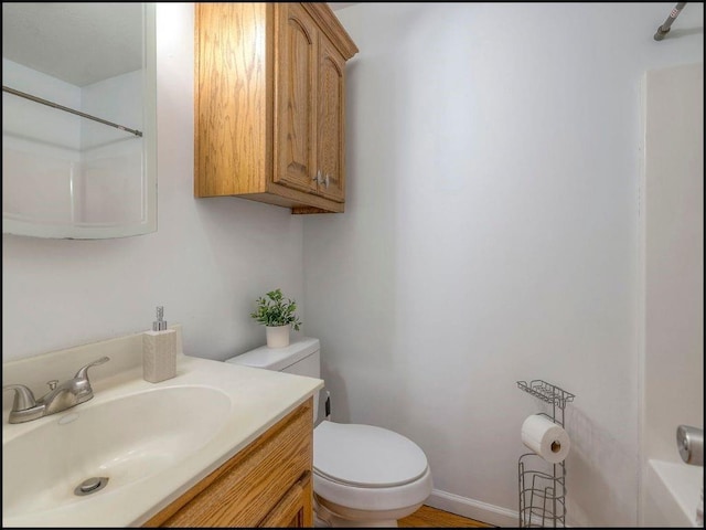 bathroom featuring vanity and toilet