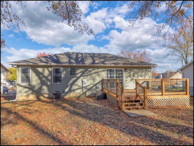 rear view of house with central air condition unit and a wooden deck