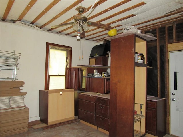 interior space with concrete floors and ceiling fan