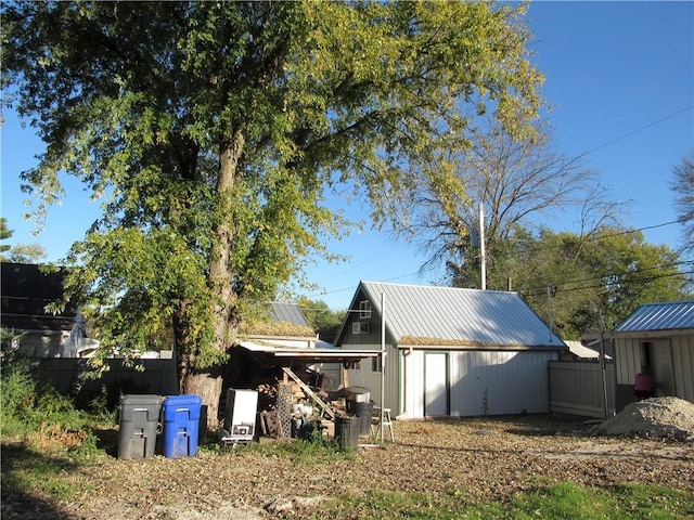 rear view of house with a storage unit