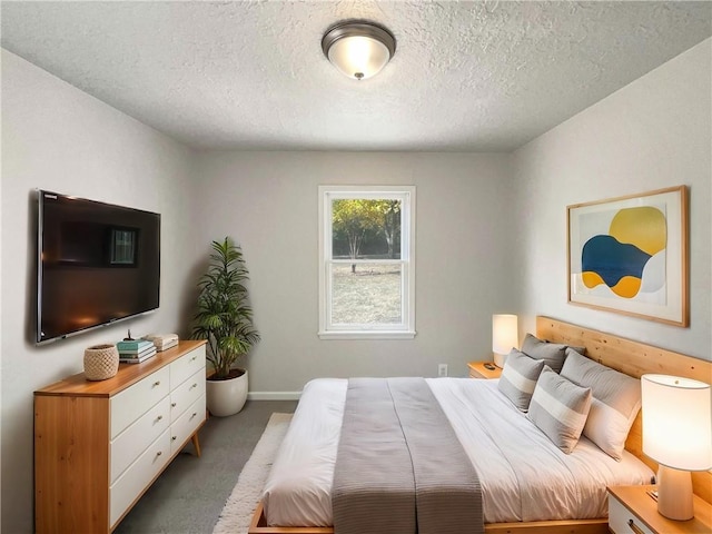 carpeted bedroom with a textured ceiling