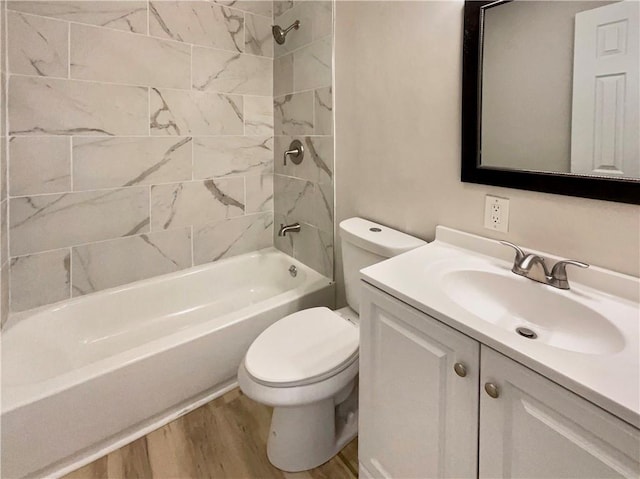 full bathroom featuring vanity, toilet, hardwood / wood-style floors, and tiled shower / bath