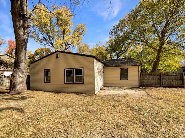 rear view of property featuring a lawn