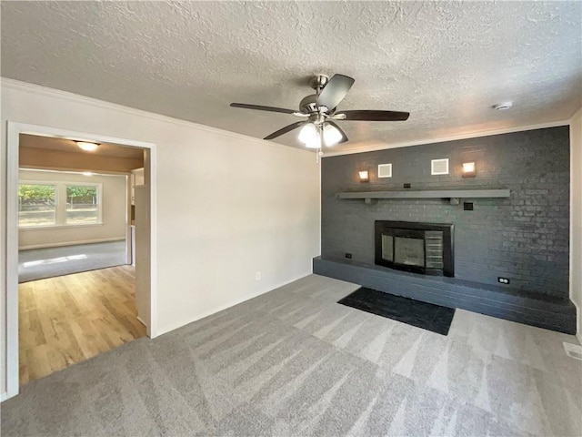 unfurnished living room featuring light carpet, a textured ceiling, and ceiling fan