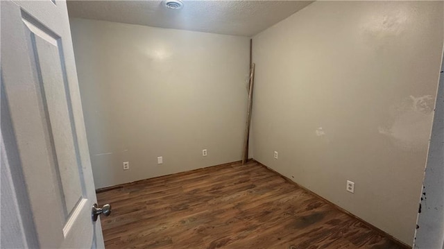 empty room featuring dark hardwood / wood-style floors