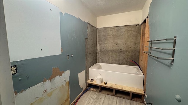 bathroom with a tub to relax in