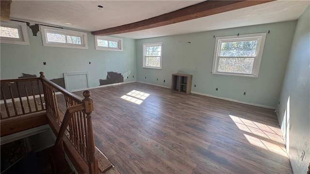 interior space featuring beamed ceiling and hardwood / wood-style floors