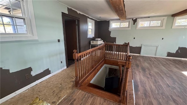 interior space featuring hardwood / wood-style floors and beamed ceiling