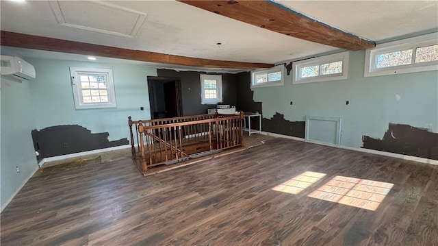 basement featuring a wall mounted AC and dark wood-type flooring