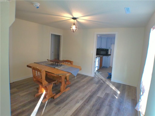 unfurnished dining area featuring a wealth of natural light and wood-type flooring