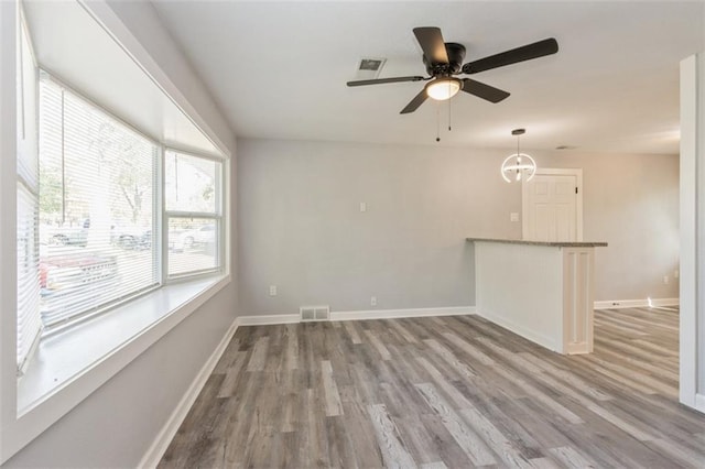 unfurnished room with light wood-type flooring and ceiling fan