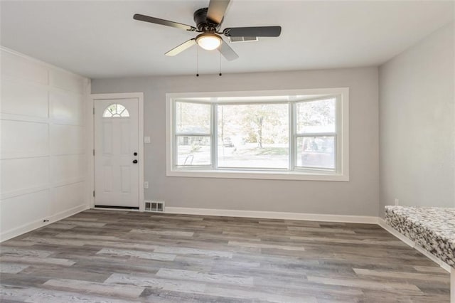 foyer featuring a wealth of natural light, ceiling fan, and light hardwood / wood-style flooring