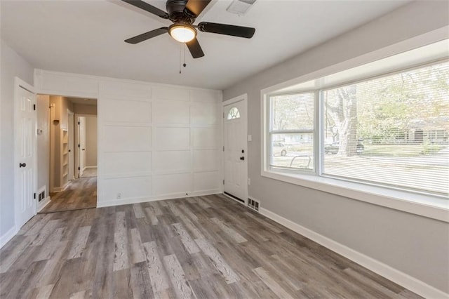 empty room featuring light wood-type flooring and ceiling fan