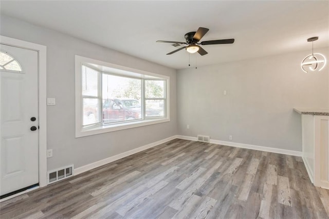 foyer entrance featuring ceiling fan, a healthy amount of sunlight, and light hardwood / wood-style flooring