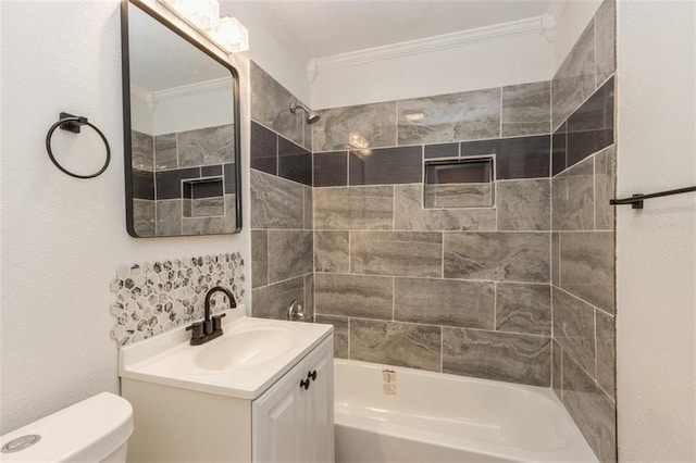 full bathroom featuring toilet, vanity, tiled shower / bath, and ornamental molding