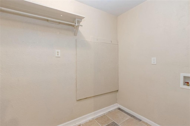 clothes washing area featuring tile patterned flooring and hookup for a washing machine