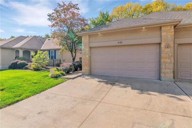 view of front of property with a front yard and a garage