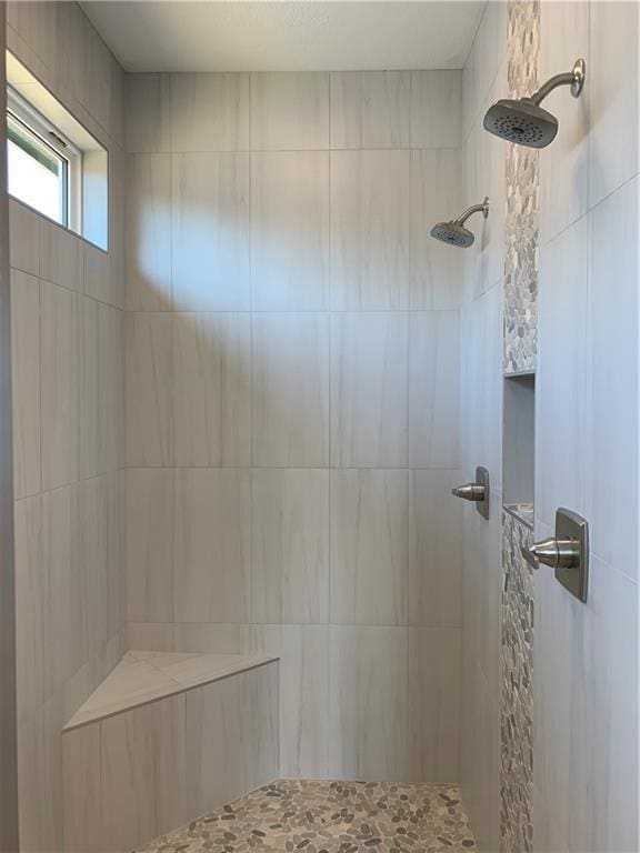 bathroom featuring tiled shower