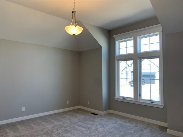 spare room with visible vents, baseboards, and light carpet