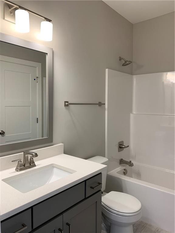 full bath featuring toilet, shower / washtub combination, and vanity