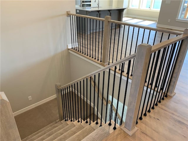 stairs featuring baseboards and wood finished floors