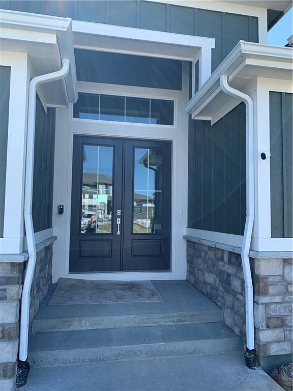 property entrance with stone siding and french doors