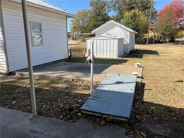 view of yard with a storage shed and a patio