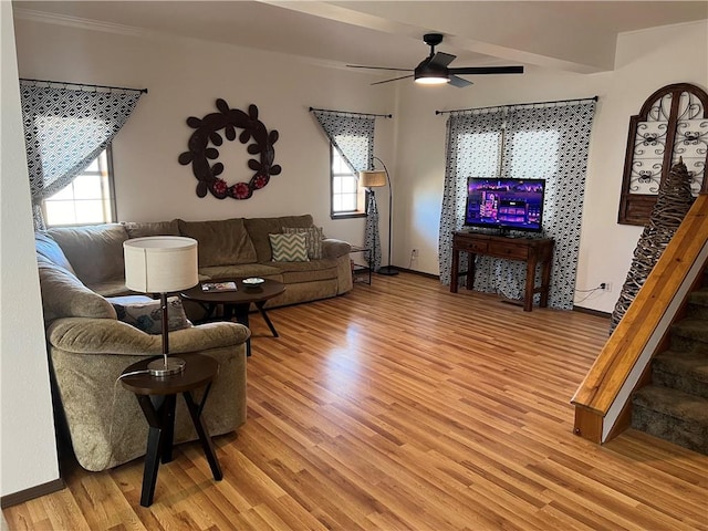 living room featuring light wood-type flooring and ceiling fan