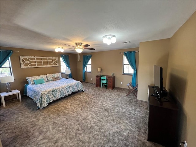 bedroom featuring a textured ceiling, carpet flooring, and ceiling fan