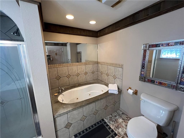 bathroom featuring toilet and separate shower and tub