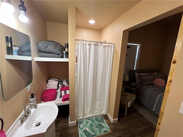 bathroom featuring a shower with curtain, sink, and wood-type flooring