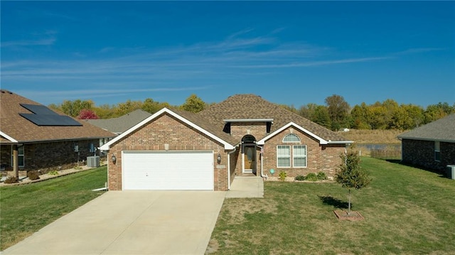 ranch-style house with central AC unit, a garage, and a front yard