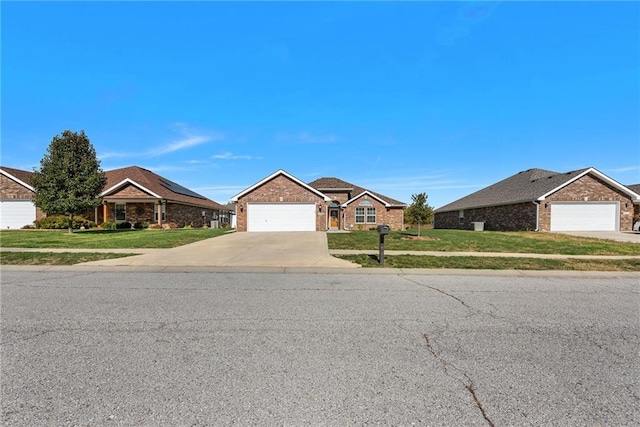 ranch-style house featuring a front yard and a garage