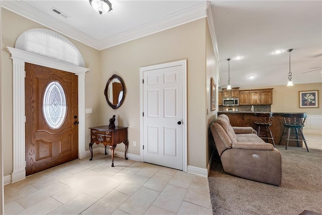 tiled foyer entrance with ornamental molding