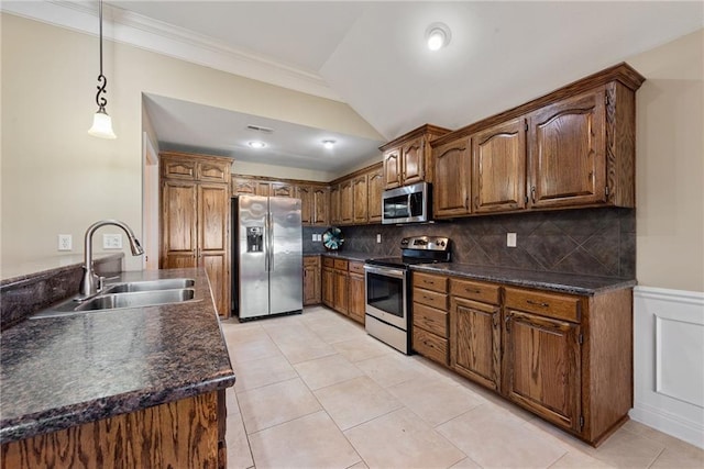 kitchen featuring sink, stainless steel appliances, backsplash, pendant lighting, and light tile patterned floors