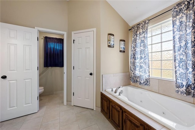 bathroom featuring tile patterned flooring, toilet, lofted ceiling, and a washtub