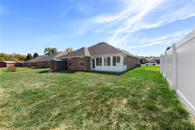 rear view of house with a yard