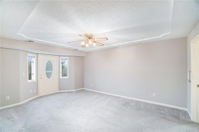 carpeted entrance foyer featuring ceiling fan and a textured ceiling