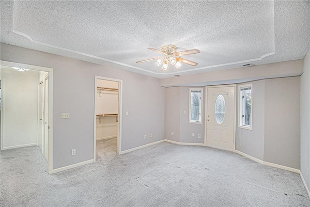 interior space with a textured ceiling and ceiling fan