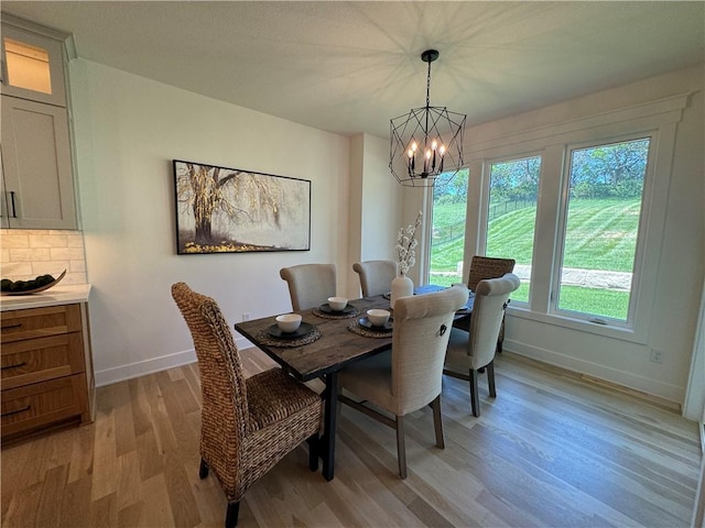 dining room featuring a chandelier and light wood-type flooring