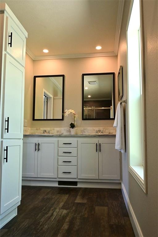 bathroom featuring vanity, hardwood / wood-style floors, and crown molding