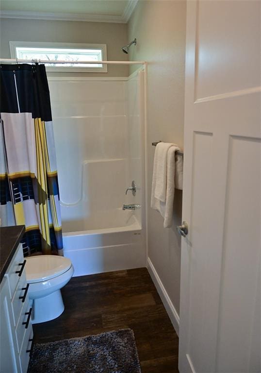 full bathroom featuring crown molding, vanity, toilet, hardwood / wood-style flooring, and shower / tub combo with curtain