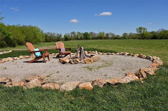 view of yard featuring a rural view and an outdoor fire pit